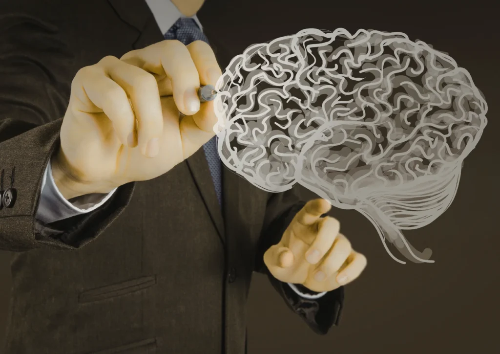 A person in a suit draws a stylized white brain on transparent glass with a pen. The image conveys innovation and intelligence in a professional context.